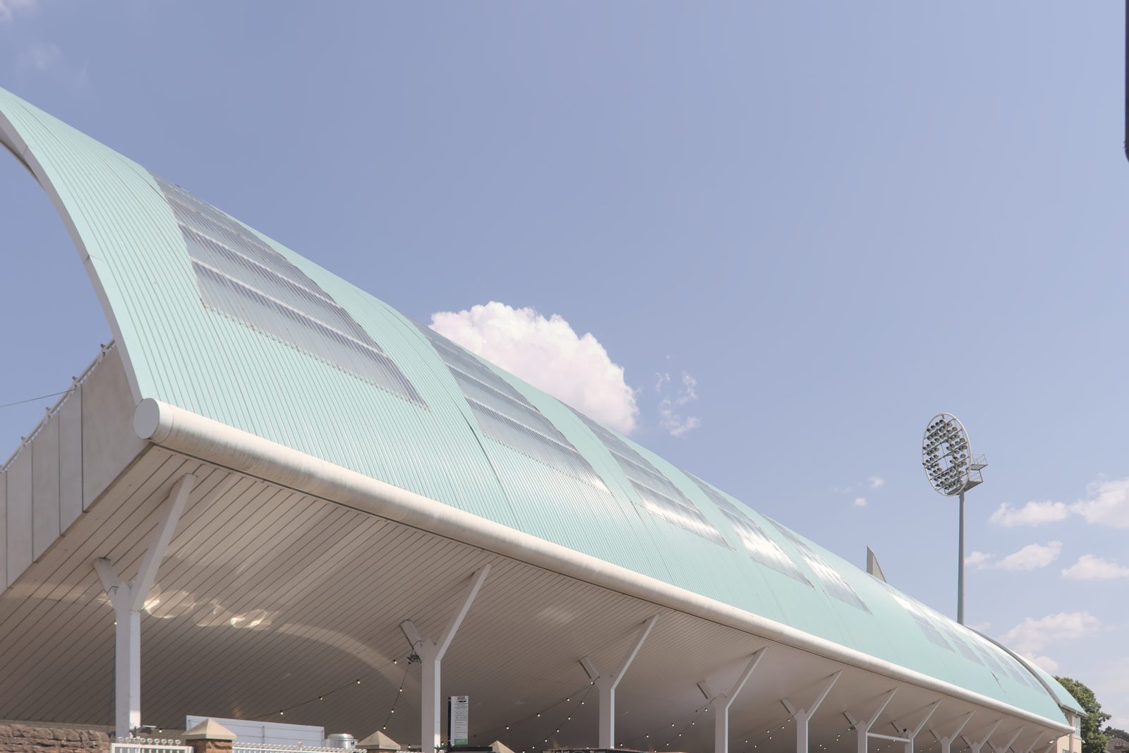 The curved roof of the Bridgford Road Stand at Trent Bridge, photographed from outside the ground in July 2026.