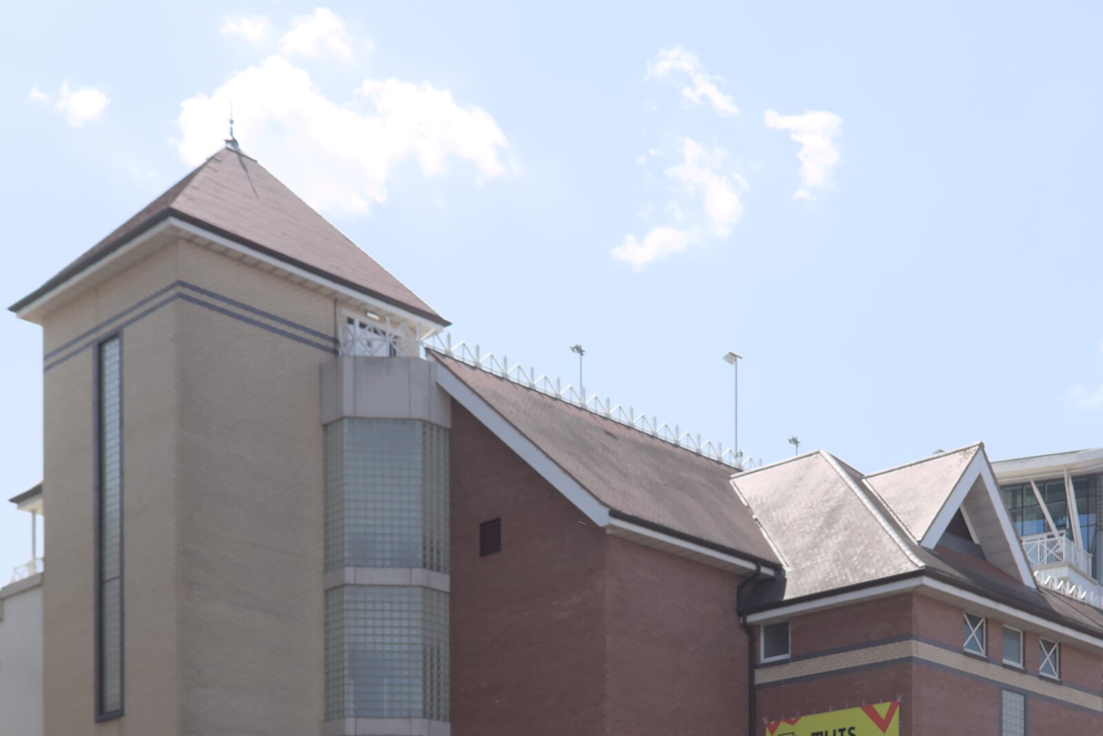 The Radcliffe Road Stand at Trent Bridge, with its brick tower and pitched roofs beneath a blue sky.